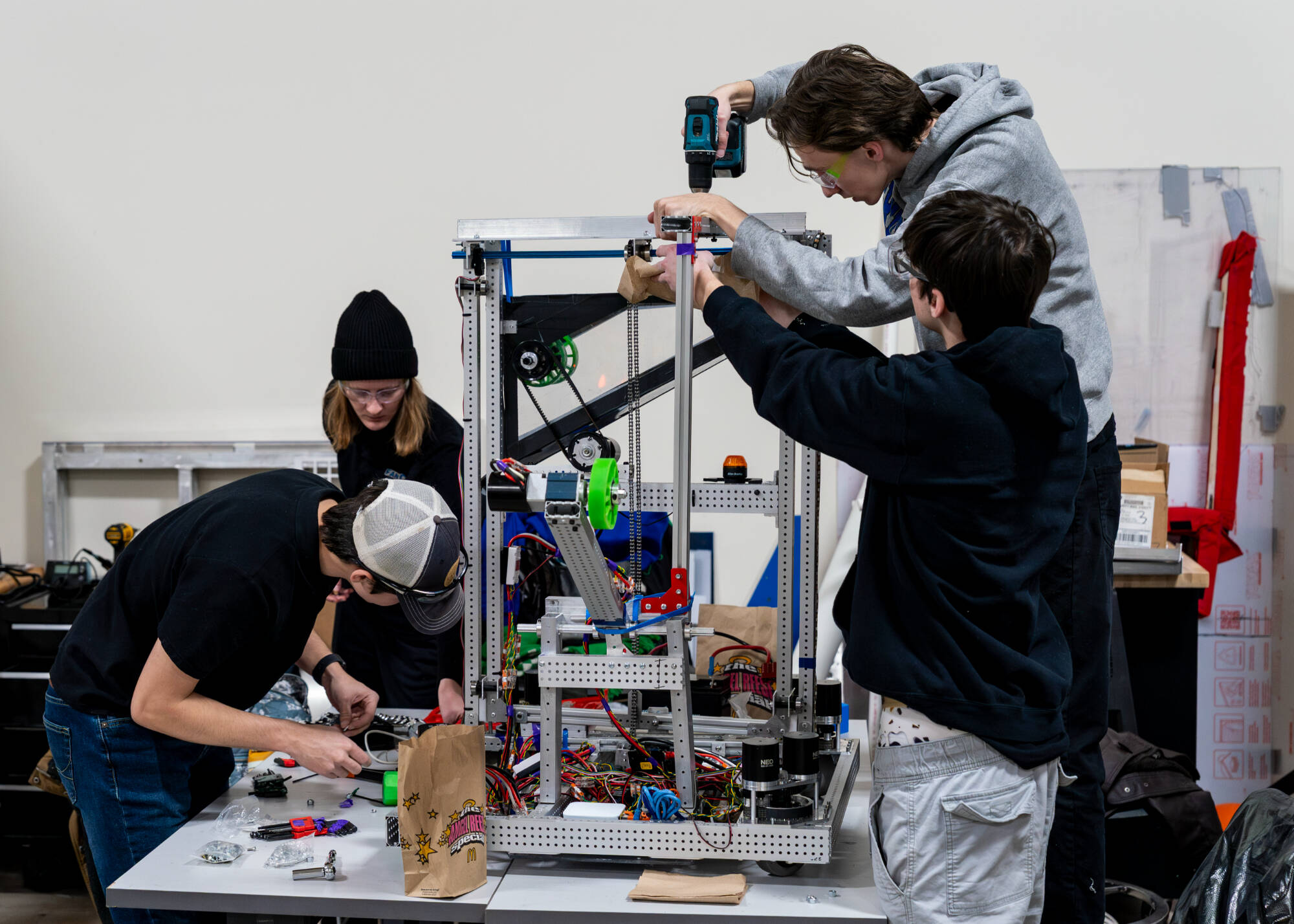 (Clockwise from bottom left) Mechanical engineering major Aidan Ward, mechanical engineering major Briquell Jipping, product design and manufacturing engineering major Logan Weisner and mechanical engineering major Jake Kimsella  work during the GVSU F...